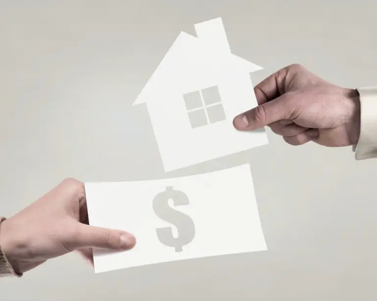 Two hands exchange cutouts—a house and a dollar sign—symbolizing mortgage lender-assisted home purchases.