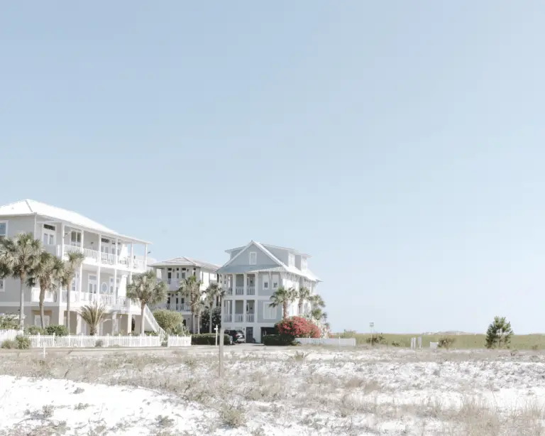 Pastel-colored beach houses with palm trees—your dream escape made possible with flexible home loans.
