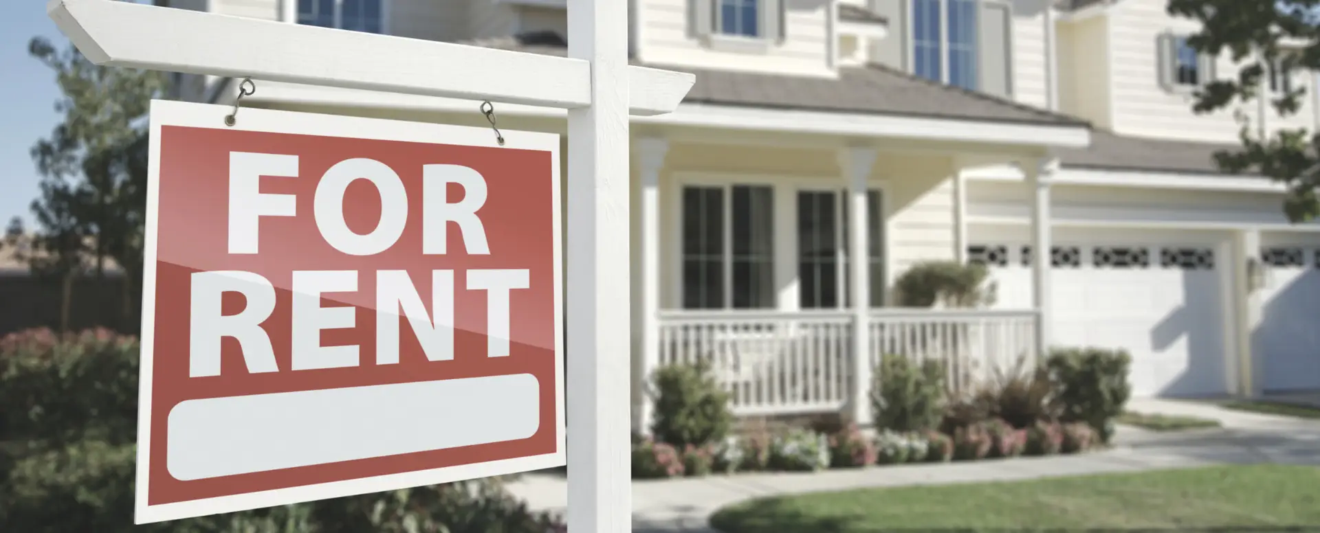 A For Rent sign in front of a beige suburban house—ideal for first-time home buyers exploring future home loans.