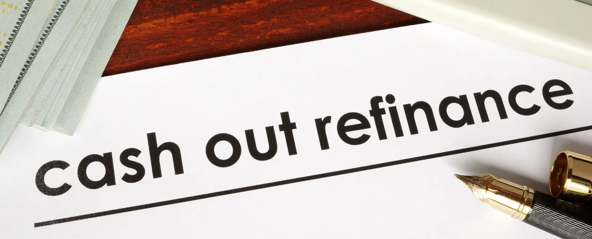 A document titled cash out refinance sits beside a fountain pen and checkbook, ideal for first-time home buyers.