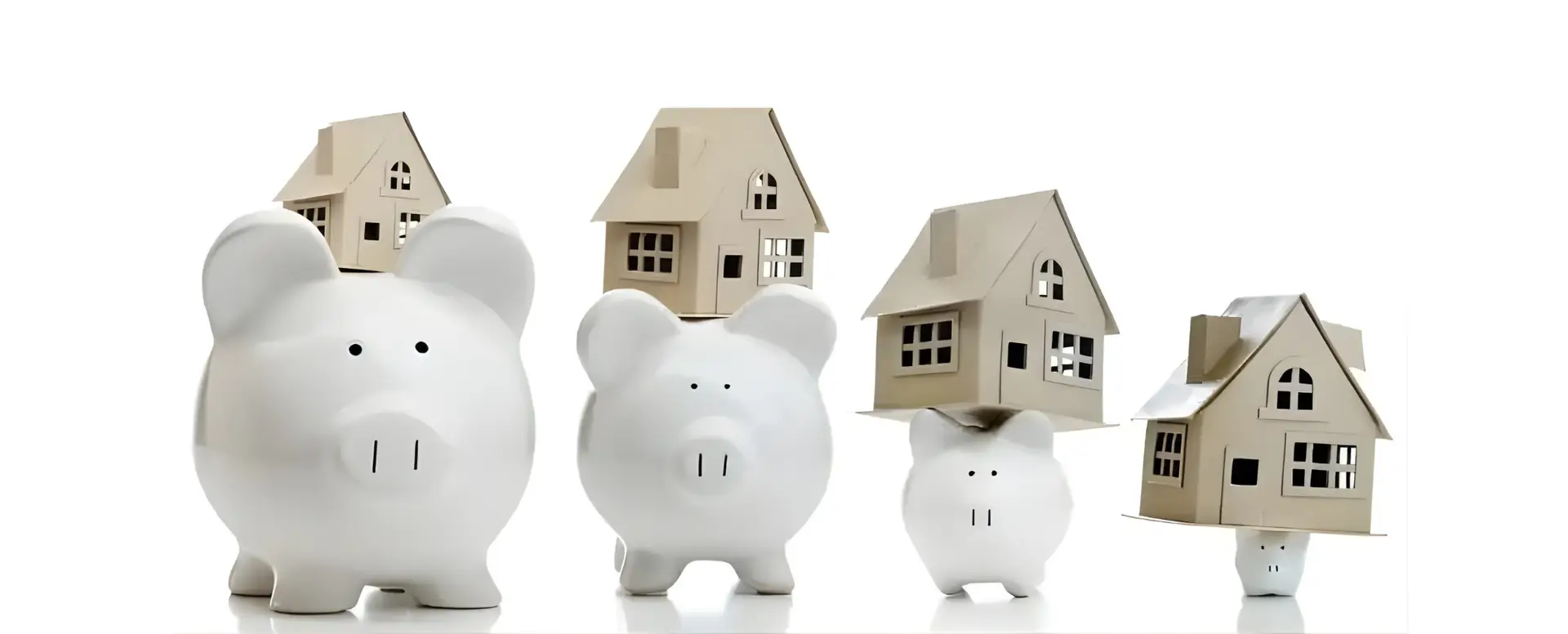 Four piggy banks with model houses on top, symbolizing saving for first-time home buyers, on a white background.