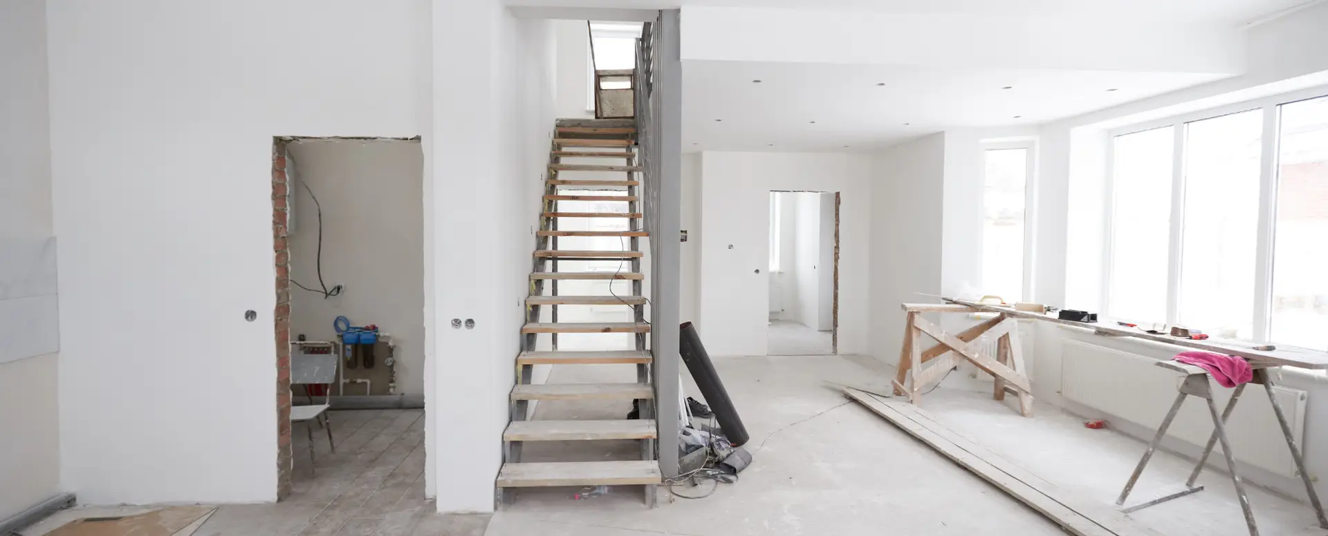 A modern, white-walled room under renovation—ideal for first-time home buyers or those considering mortgage refinance.